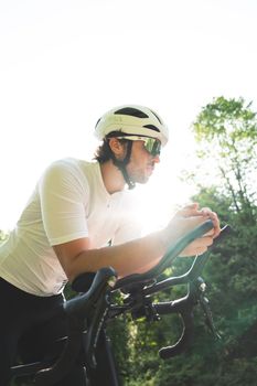 A cyclist with a helmet rides a bike outdoors on a sunny day, capturing the essence of outdoor sports.