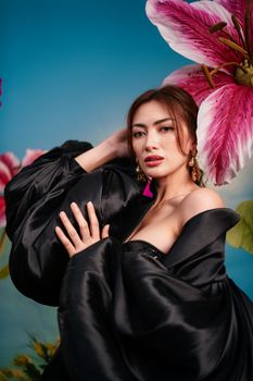 Dramatic portrait of a woman with oversized flowers, exuding elegance.