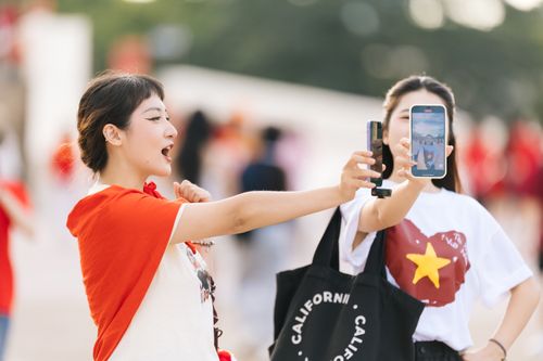 Free Two young women take a joyful selfie in a vibrant outdoor setting, capturing their excitement. Stock Photo