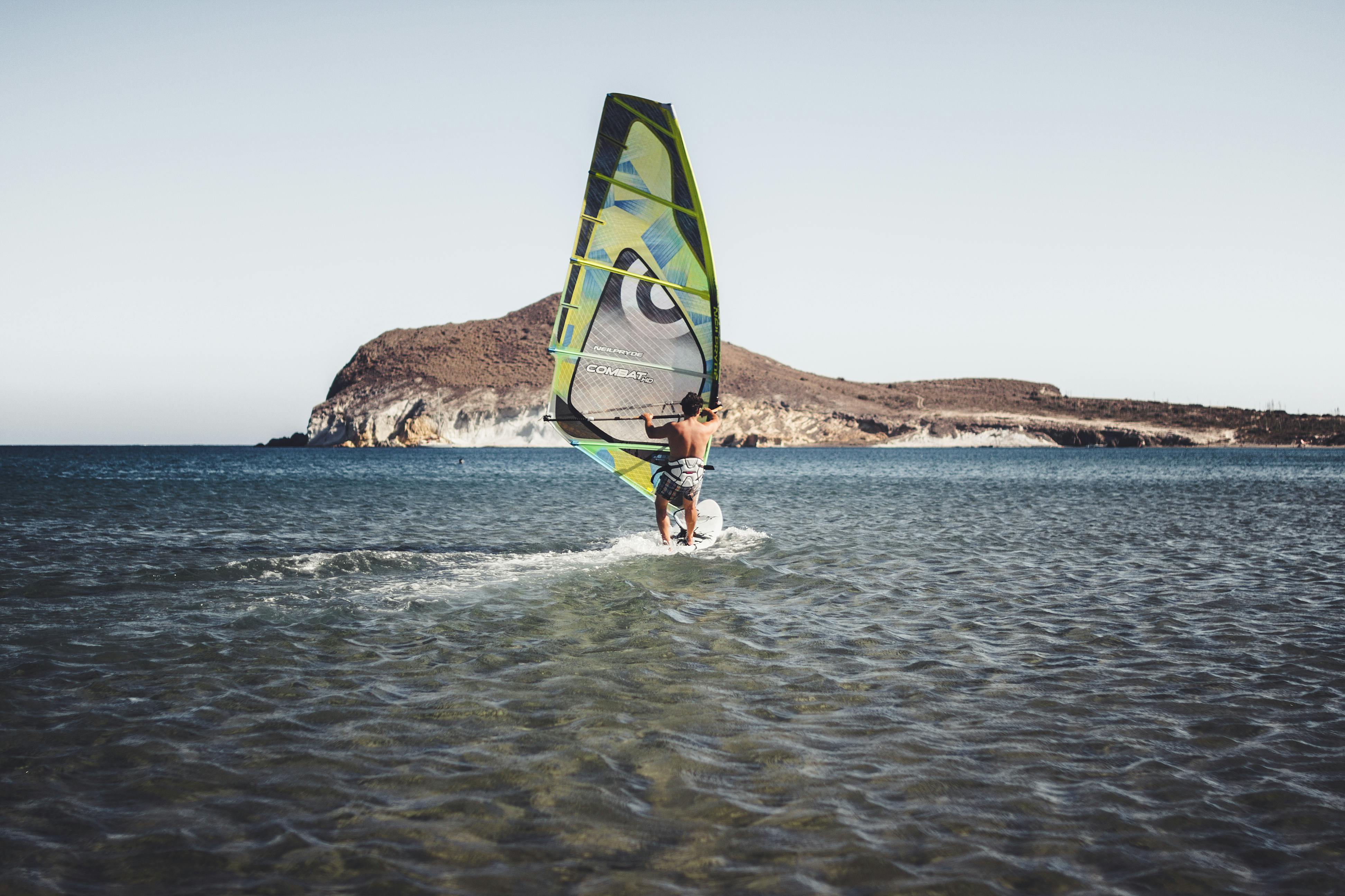 Man Riding Green And Black Boat On Water · Free Stock Photo