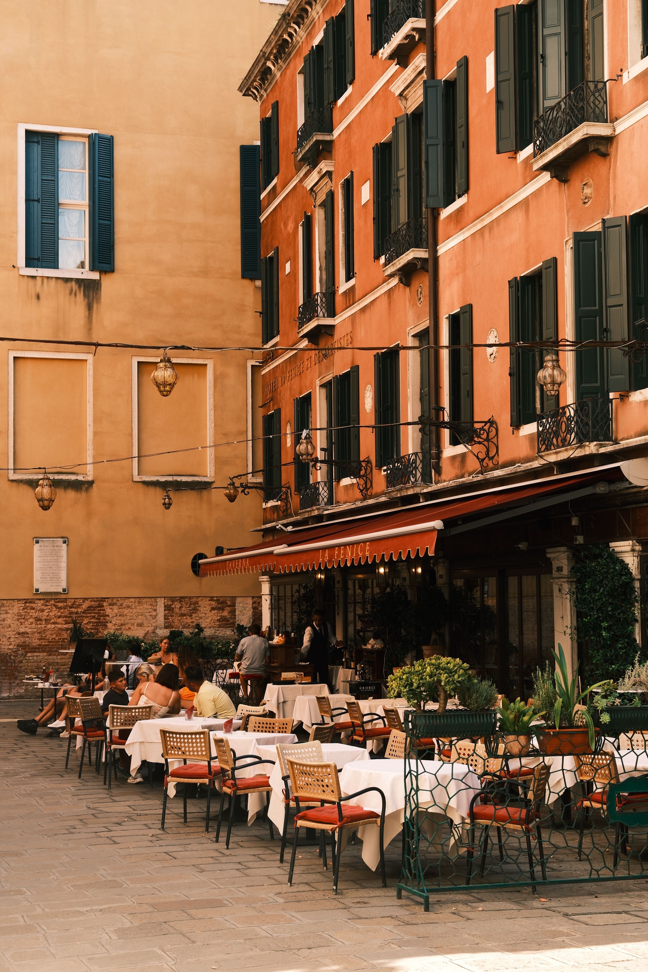 Picturesque outdoor cafe in Venice with classic architecture and dining ambiance.
