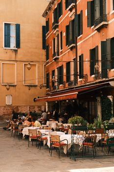 Picturesque outdoor cafe in Venice with classic architecture and dining ambiance.