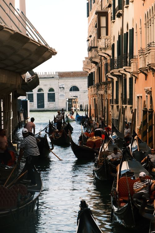 Free Crowded Venetian canal with gondolas navigating through historic buildings. Stock Photo