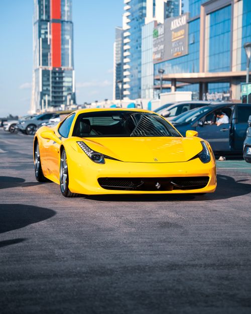 Free Vibrant yellow sports car parked amidst modern architecture in Ankara, Türkiye. Stock Photo
