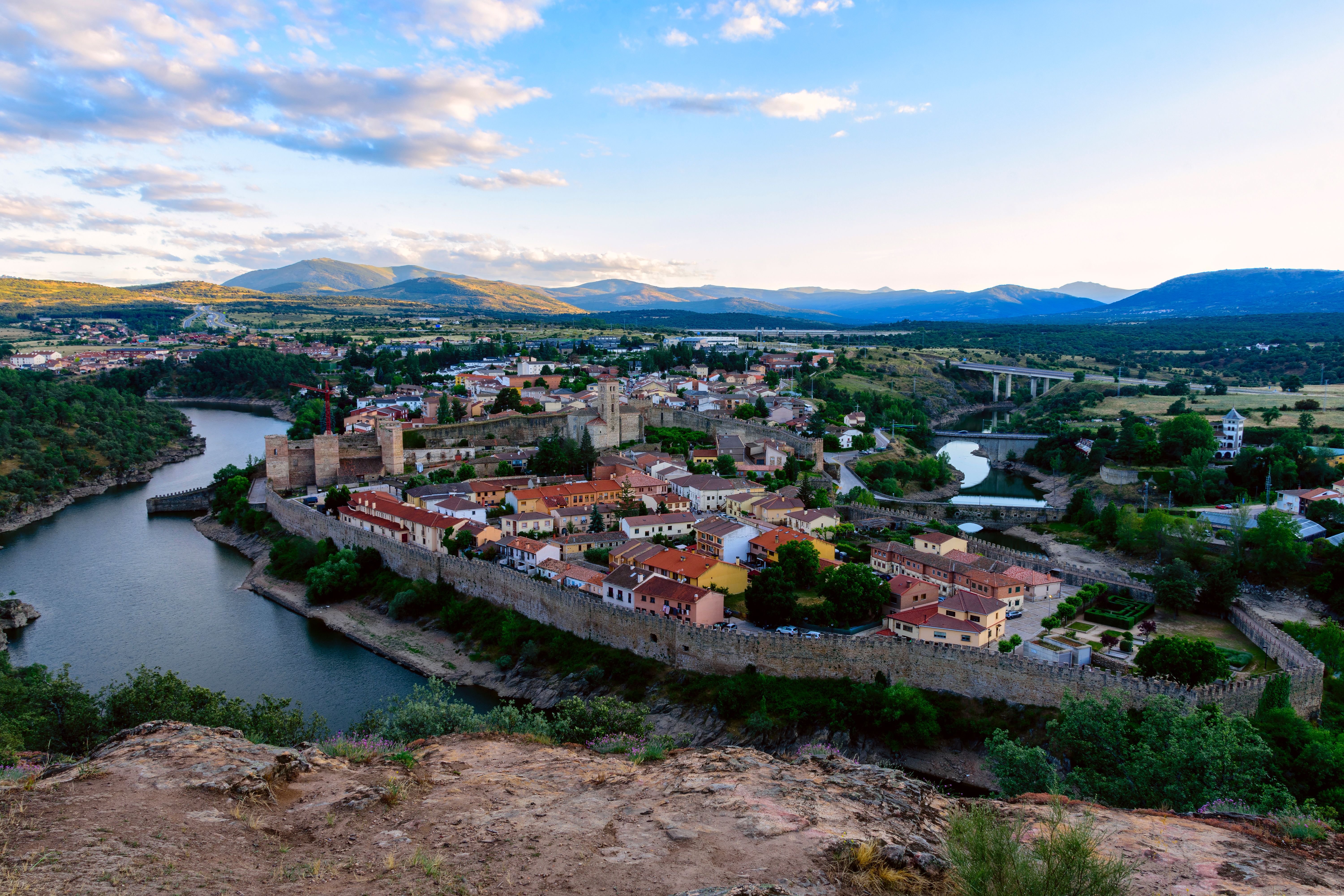 Scenic aerial view of Buitrago del Lozoya, showcasing medieval architecture and lush landscape.