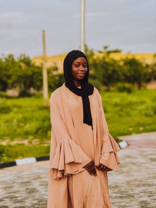 Free A woman in a hijab stands gracefully outdoors, showcasing cultural elegance. Stock Photo