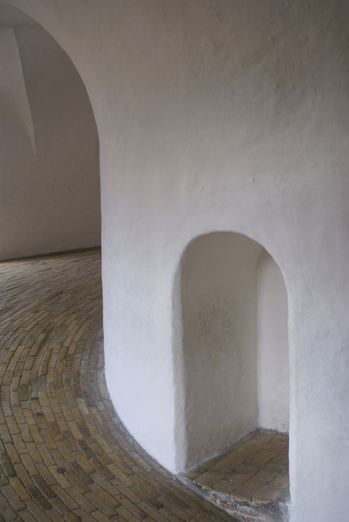 Free Curved white walls and brick floor showcasing minimalist architecture. Stock Photo
