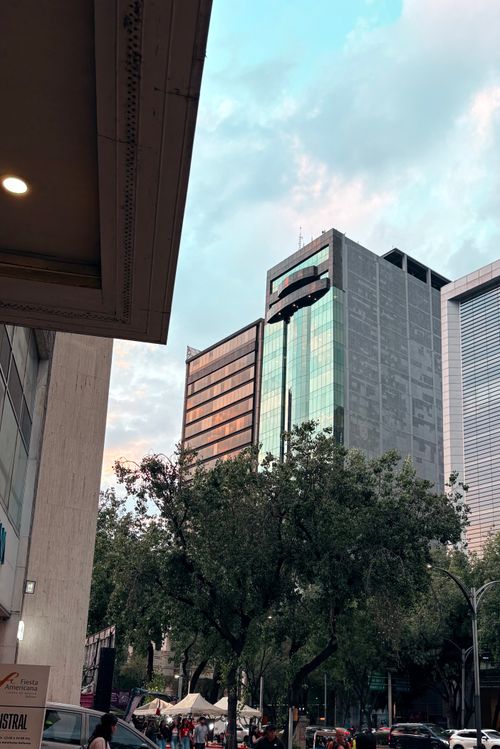 Free View of modern skyscrapers and urban life in downtown Ciudad de México, showcasing vibrant cityscape under a bright sky. Stock Photo