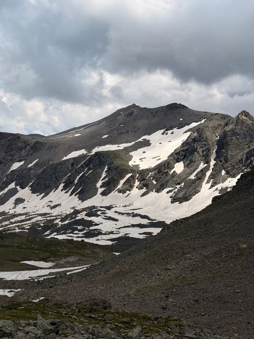 Free Dramatic view of snowcapped peaks in the Caucasus Mountains beneath moody skies. Stock Photo