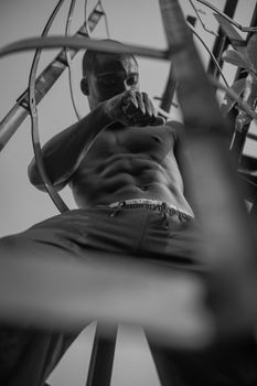 Strong athletic male posing in an urban, black and white setting.