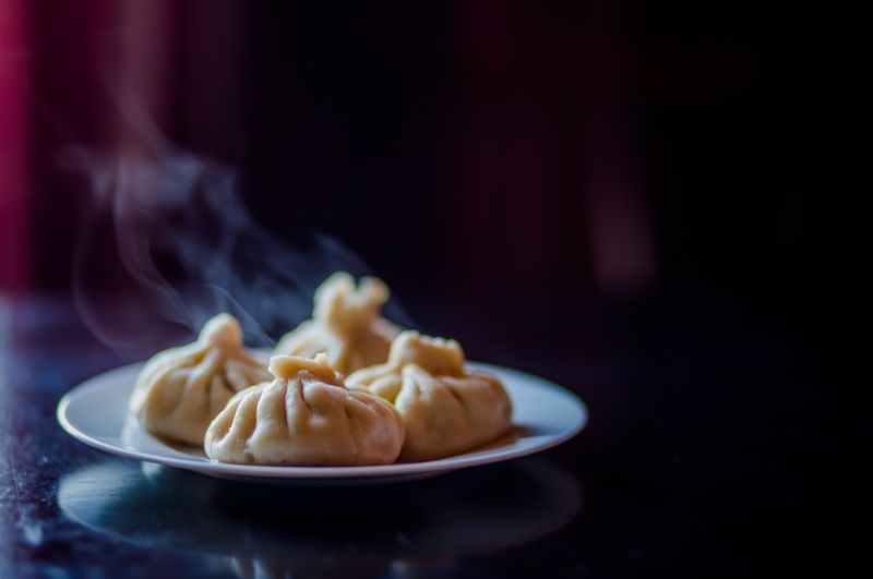 Cabbage dumplings steaming in a bamboo steamer basket