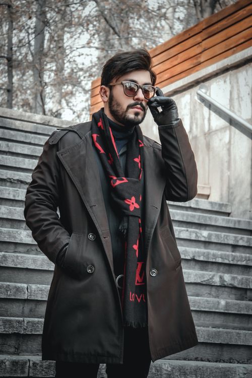 Free Fashionable man with sunglasses in Tehran, wearing a stylish overcoat. Stock Photo