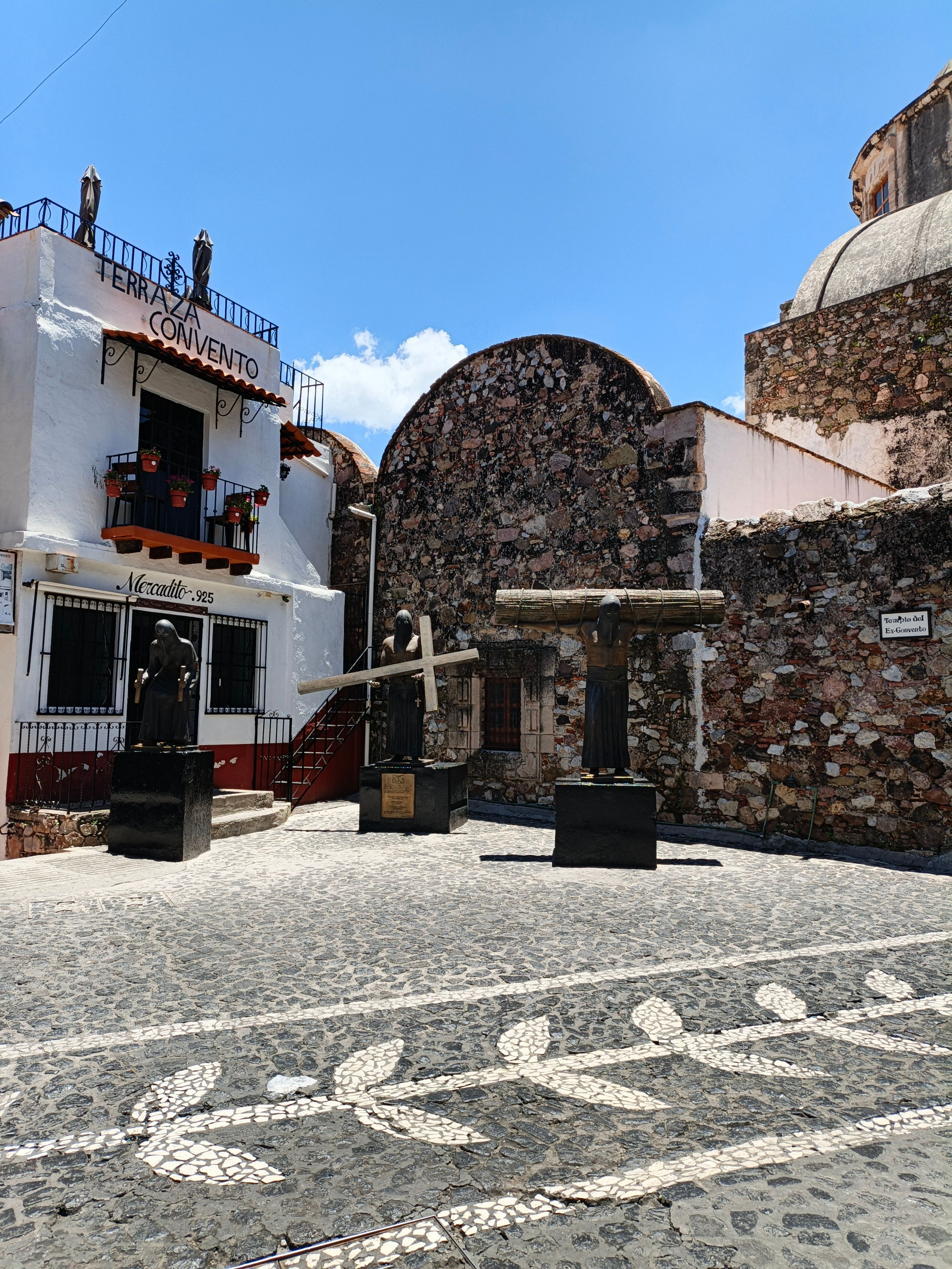 Cultural Mexican street scene with stone buildings and statues in Gro., Mexico.