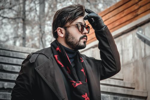 Free Stylish man in winter clothes, outdoors in Tehran, adjusting glasses on a cold day. Stock Photo