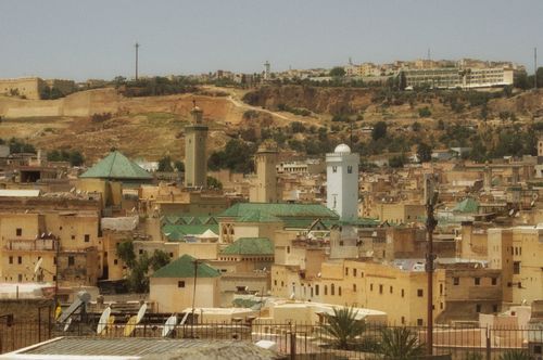 Free Panoramic view of Fes, Morocco showcasing historic architecture with green rooftops and warm tones. Stock Photo