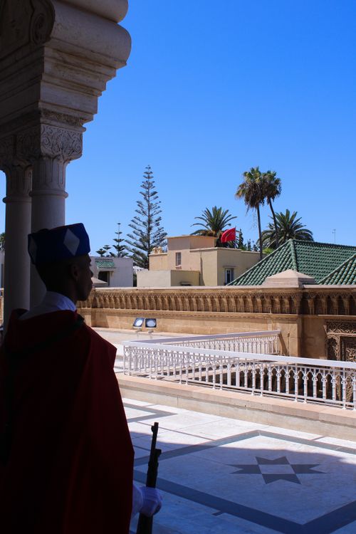 Free A guard in traditional attire stands at Rabat's Royal Palace, Morocco under blue skies. Stock Photo