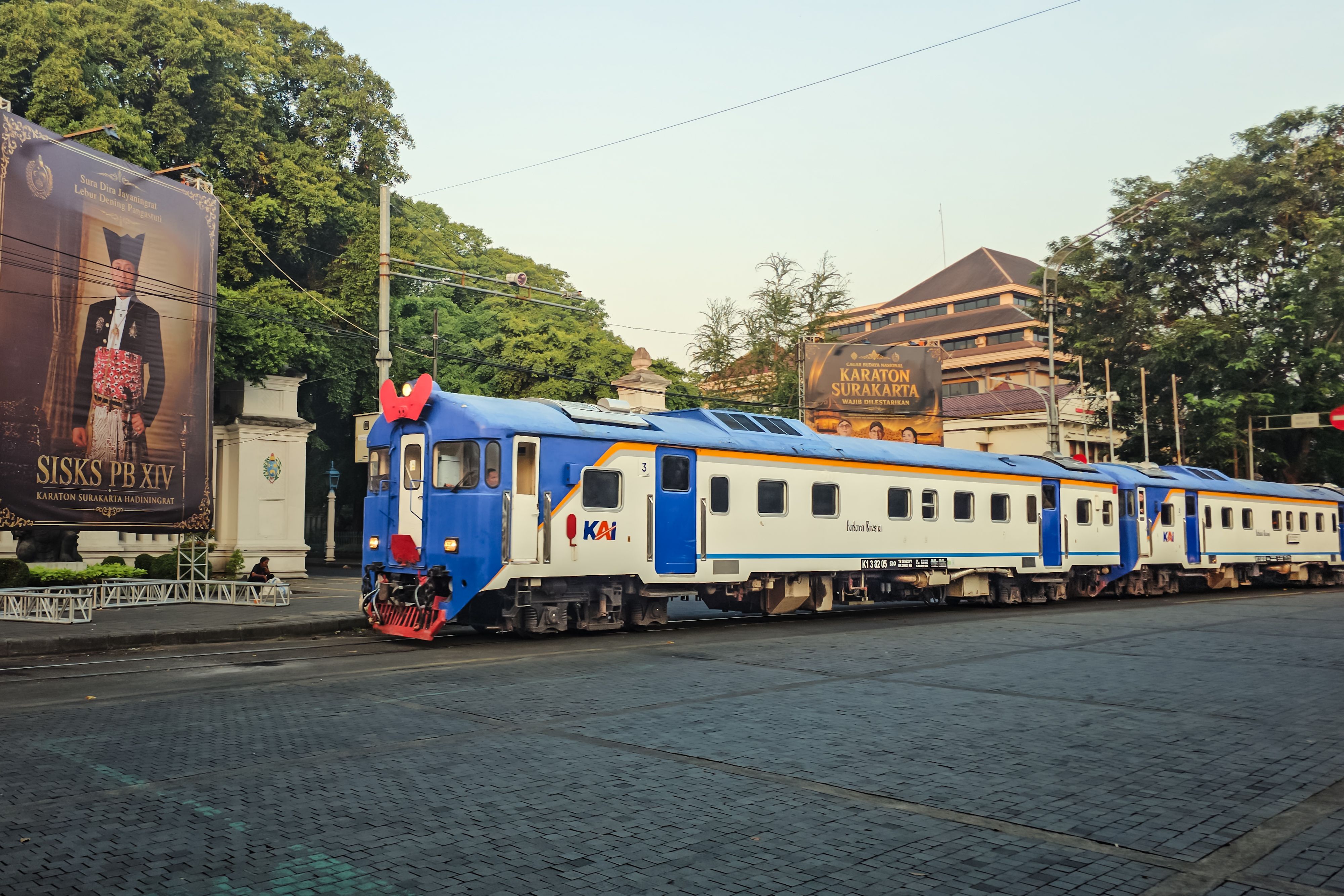 A commuter train passing by the historic Karaton Surakarta in Central Java, Indonesia.