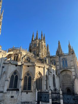 Beautiful view of Burgos Cathedral under a clear blue sky, showcasing Gothic architecture.