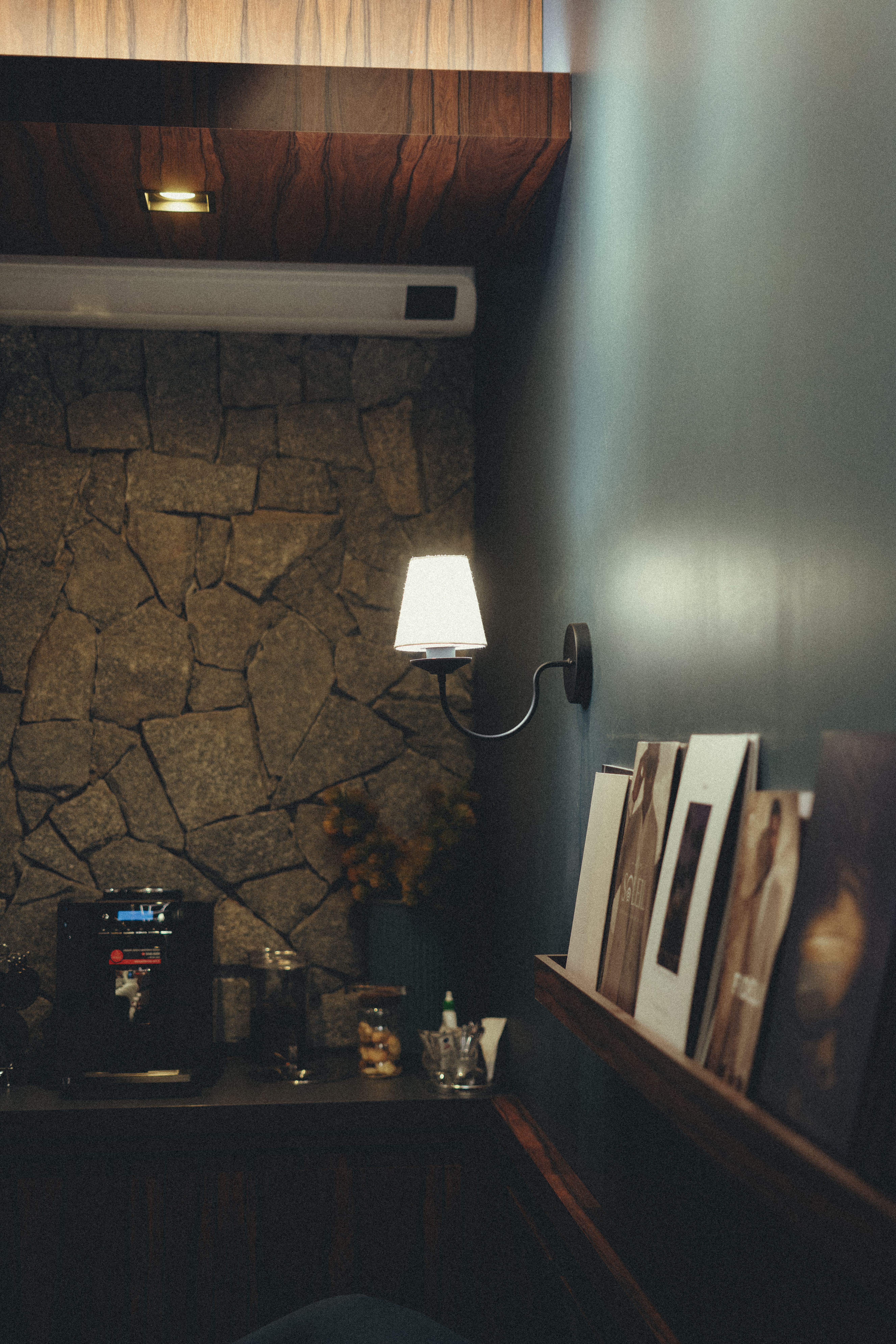 Pair of matte black sconces mounted on the wall next to a modern minimalist coffee bar