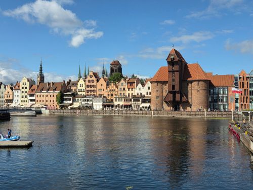 Free Beautiful sunny day at the historic Gdańsk Old Town waterfront with iconic architecture. Stock Photo
