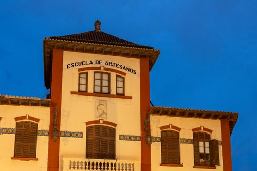 Free Captivating night view of the Escuela de Artesanos in Valencia with blue hour ambiance and historic architecture. Stock Photo