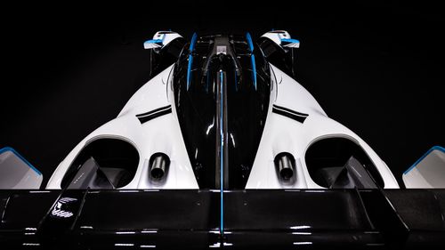 Free A stunning top-down view of a sleek, aerodynamic race car with black, white, and blue accents. Stock Photo