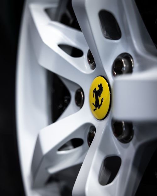 Free Detailed close-up of a luxury car wheel rim with emblem center. Stock Photo