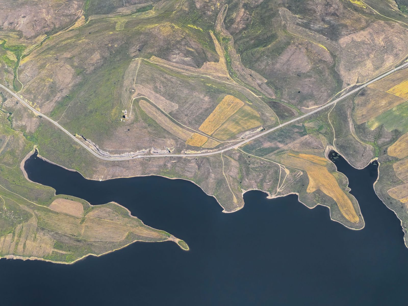 Aerial view of rolling hills and a reservoir