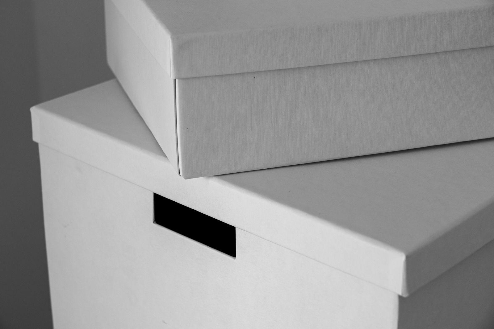 Two real rigid boxes, each with a separate lift-off lid resting on top of its base