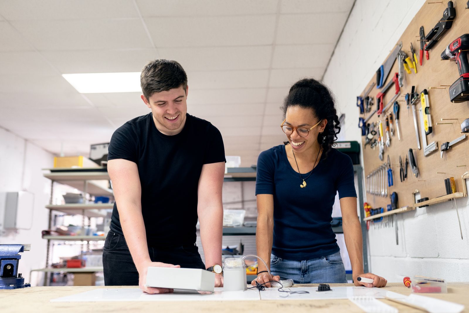 Engineering team discussing a prototype in a workshop