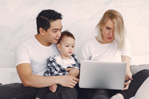 Free Man And Woman In White Crew Neck Shirt Looking At A Laptop Stock Photo