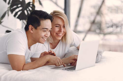 Man And Woman Looking At Laptop