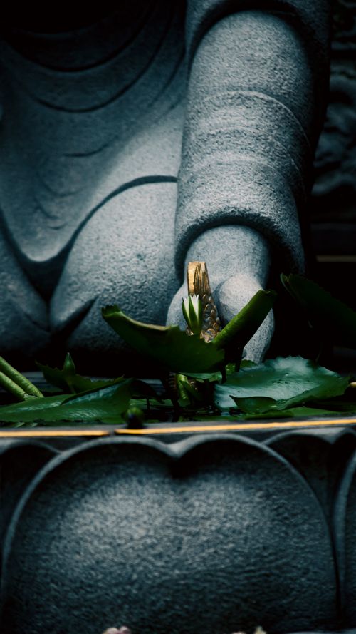 Free A calm Buddha statue hand holding a lotus flower in Ho Chi Minh City. Stock Photo