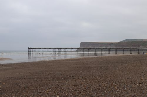 Free A tranquil scene of Saltburn Pier extending into the sea on a cloudy day. Stock Photo