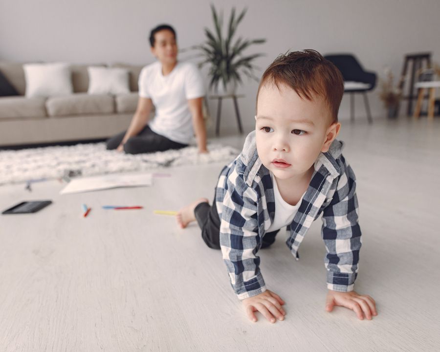 Toddler crawling on a living-room floor