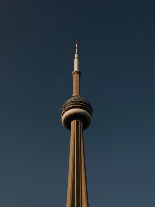 Free Stunning view of Toronto's CN Tower reaching into a clear blue sky, a hallmark of Canada. Stock Photo