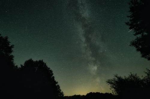 Free Stunning view of the Milky Way galaxy captured over the serene landscape of Brandenburg, Germany. Stock Photo