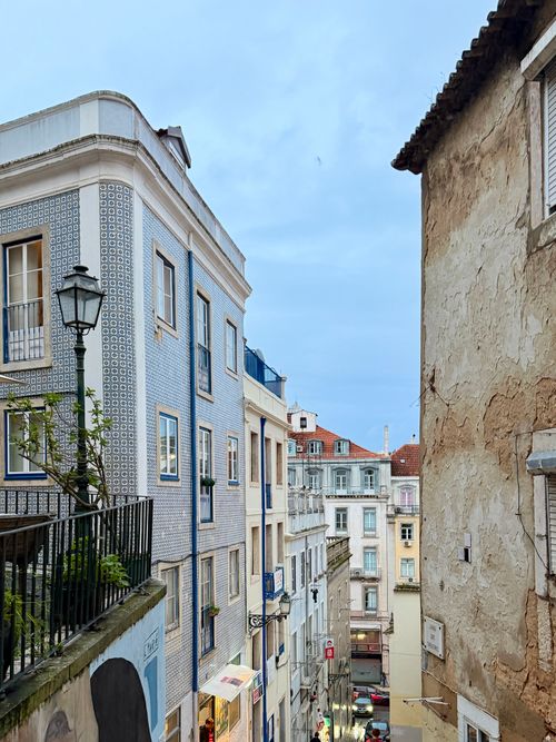 Free A picturesque street view in Lisbon featuring iconic tiled buildings and classic architecture. Stock Photo
