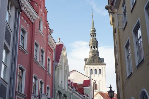 Free Charming view of Tallinn's colorful architecture and St. Olaf's Church spire against a clear sky. Stock Photo