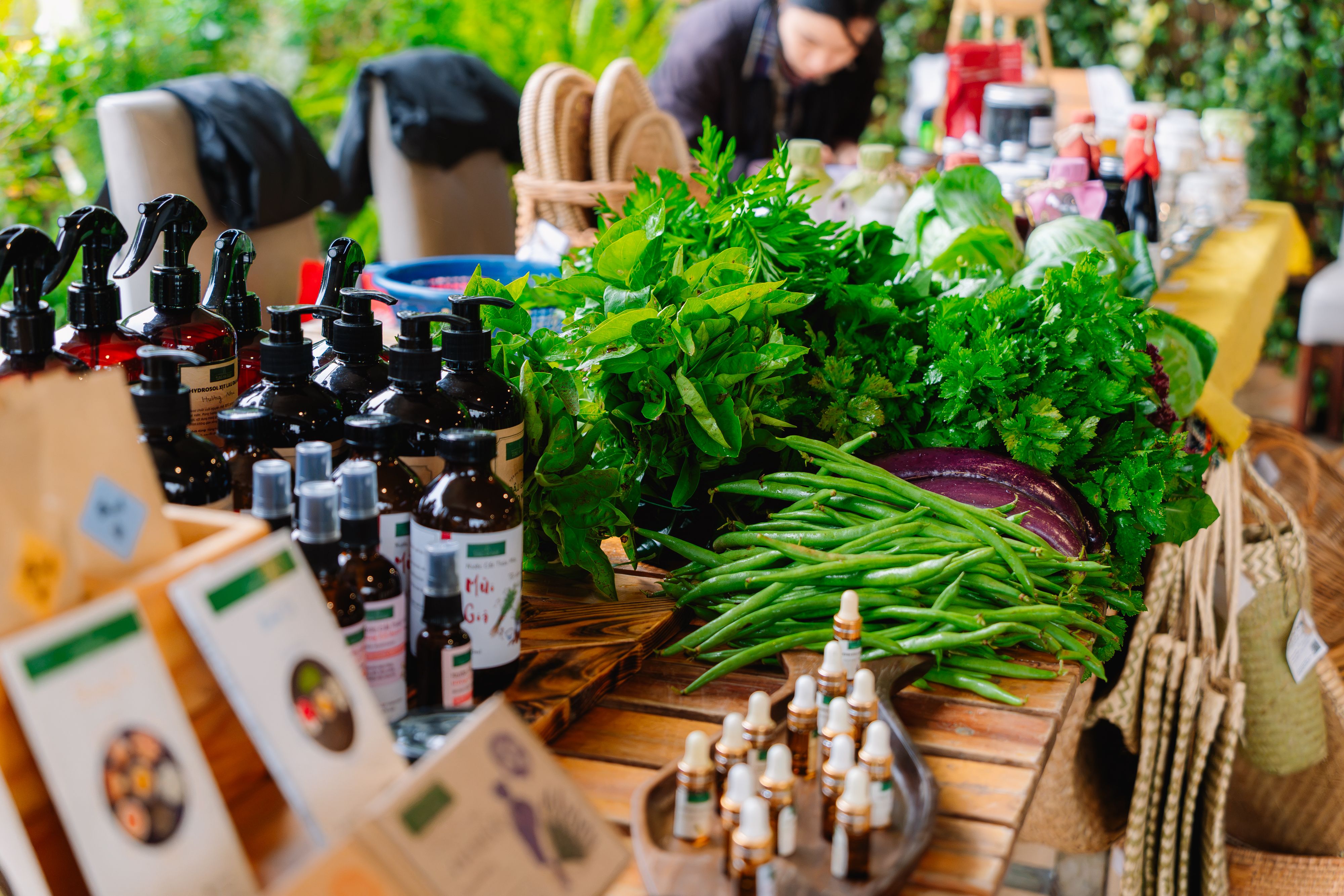 Vibrant market stall showcasing fresh greens, herbs, and organic products indoors.