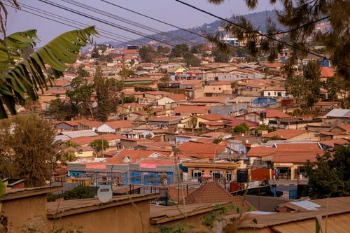 Free Aerial view of Kigali's suburban rooftops with lush hills in the background, showcasing vibrant community life. Stock Photo