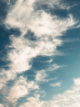 A peaceful scene of wispy clouds stretching across a clear blue sky, perfect as a calming background.