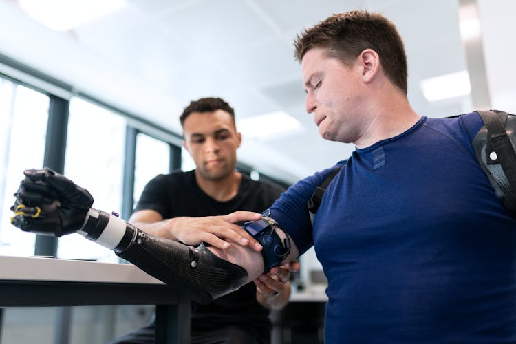 Engineer Fitting Prosthetic Arm