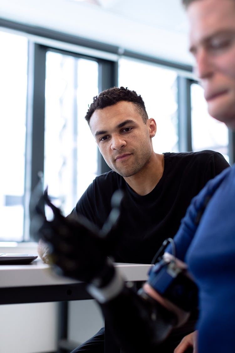 Engineer Fitting Prosthetic Arm