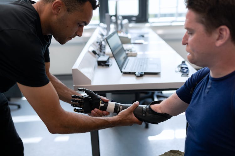 Engineer Fitting Prosthetic Arm