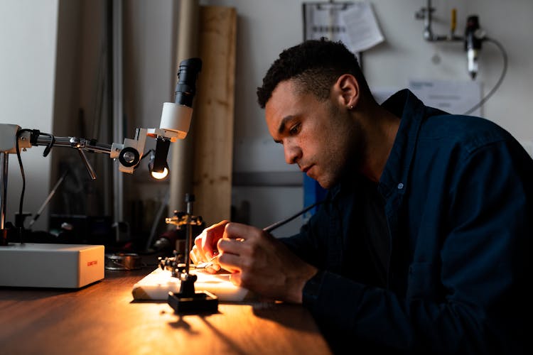 Mechanical Engineer Soldering In Workshop