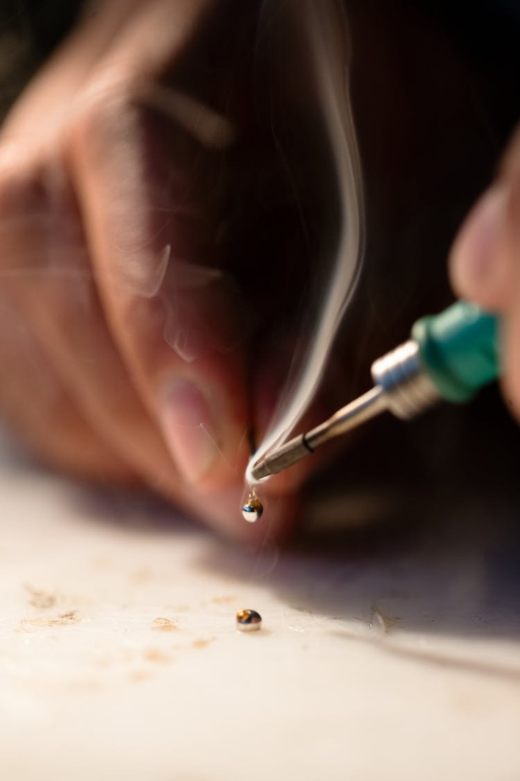 Mechanical Engineer Soldering In Workshop