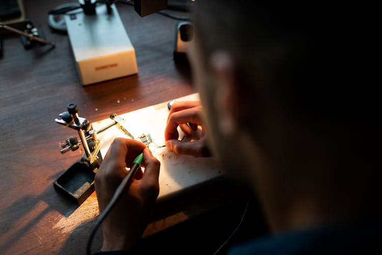 Mechanical Engineer Soldering In Workshop