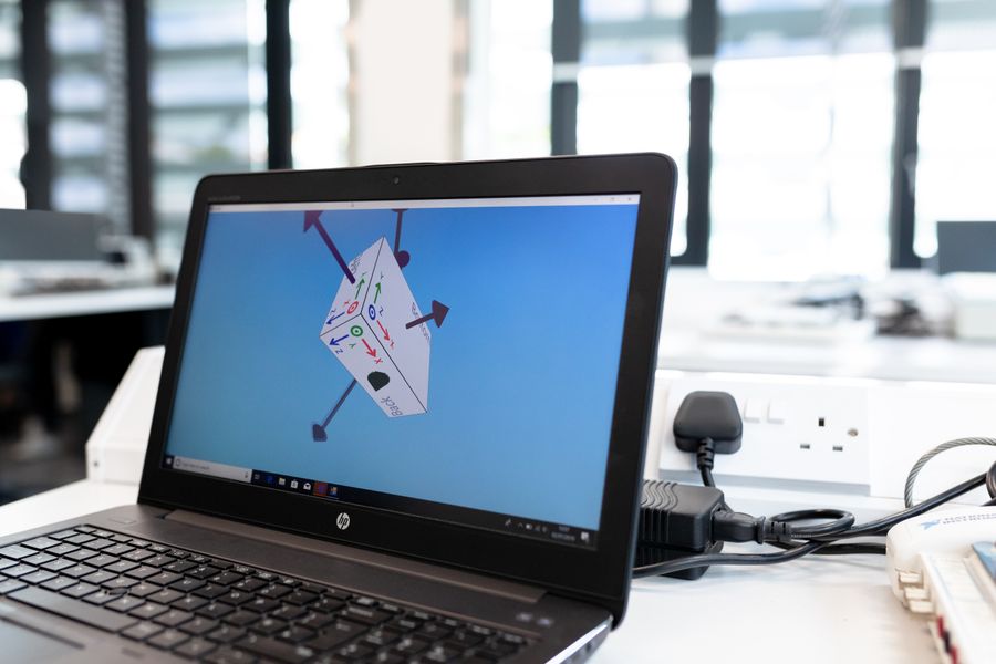 Laptop displaying design software, representing Etsy shop creation with SEO