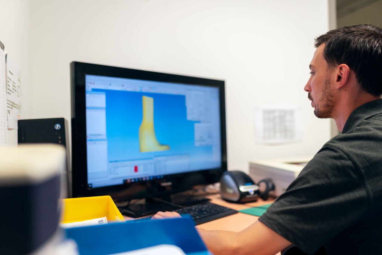 Engineer working on design using specialized software in an office setting